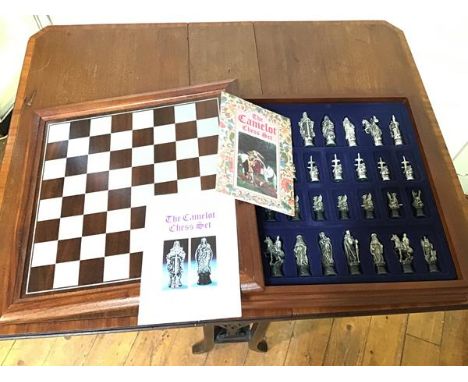 A Camelot chess set, the lift up mahogany game board over a fitted interior with Camelot themed chess pieces and associated l