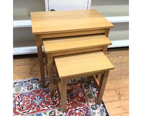 A set of three light oak nesting tables with rectangular tops on straight supports (largest: 55cm x 56cm x 35cm)