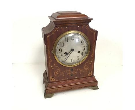 An Edwardian mahogany mantel clock, with C scroll and mother of pearl inlay, on brass bracket feet, bearing Latimer &amp; Son