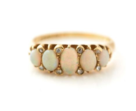 An opal and diamond ring, the five graduated opal cabochons parted by rose cut diamonds, in 18ct yellow gold mount and shank,