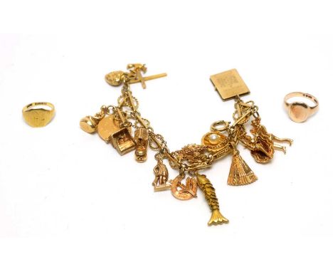 A 9ct yellow gold charm bracelet, mounted with a reticulated fish, Old Woman's Shoe, thistles, shells and others; a 9ct gold 