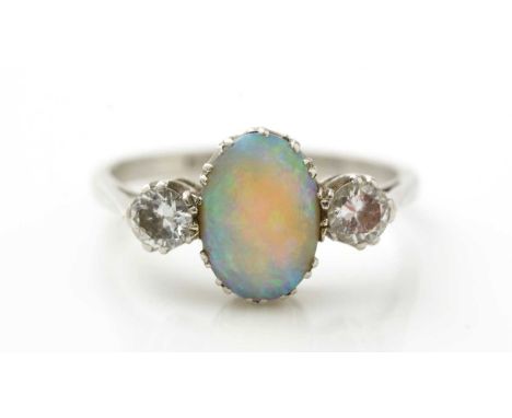 An opal and diamond ring, the oval opal cabochon flanked by brilliant cut diamonds, weighing a total of approximately 0.50car