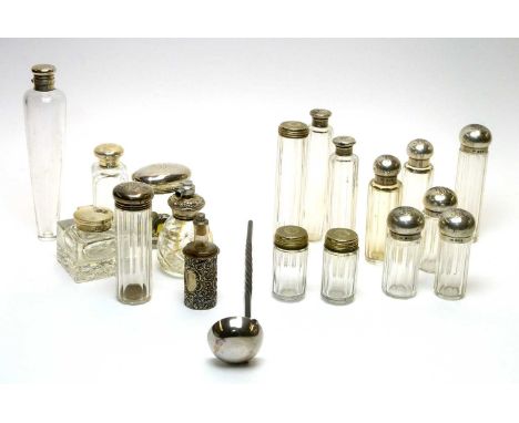 A selection of glass dressing table, scent and other bottles, mostly with silver mounts, including a stirrup decanter; and a 