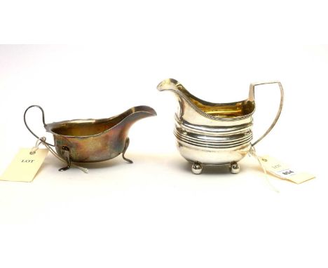 A George III silver milk jug, maker's mark rubbed, London 1808, of helmet form; and a silver sauce boat, by Edward Viners, 8.