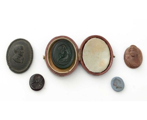 A green glass intaglio seal, engraved with a classical female nude and inscribed 'Brown'; another red glass; a carved lava st