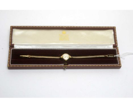 A Garrard 9ct yellow gold cased manual wind wrist watch, on gold bracelet strap, 11.9g gross, in original box. 