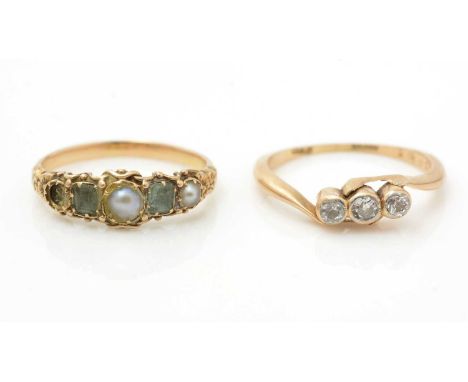 A 19th Century peridot and half pearl ring, (missing one pearl), in 18ct gold mount and shank, ring size I; and a three stone