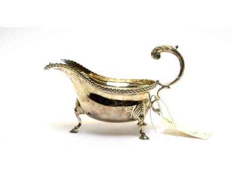 A silver sauce boat, by Stokes &amp; Ireland Ltd, Chester 132, with gadrooned rim and hoof feet, 10.6oz. 