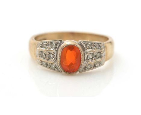 A fire opal and diamond ring, the oval facet cut opal flanked by diamond shoulders, in 9ct white gold mount and yellow gold s