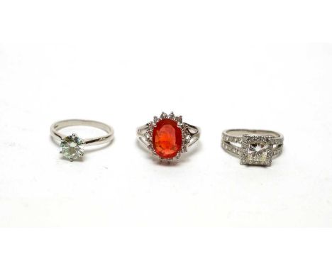 A hessonite garnet and moissanite cluster ring, on 18ct white gold mount and shank; a round brilliant cut moissanite solitair