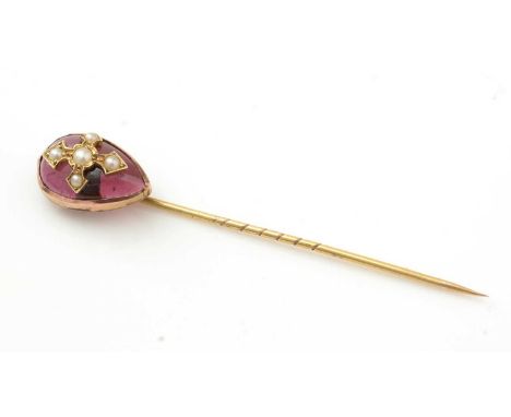A 19th Century garnet and seed pearl tie pin, the garnet cabochon set wth half seed pearls in a cross pattern, in 9ct gold mo
