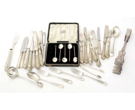 A set of silver handled tea knives; silver spoons and forks; plated items including asparagus tongs, a sauce ladle, and other