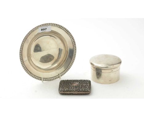 A silver circular dish with gadrooned rim; a silver cigarette case with embossed scrolls; and a cylindrical silver powder pot