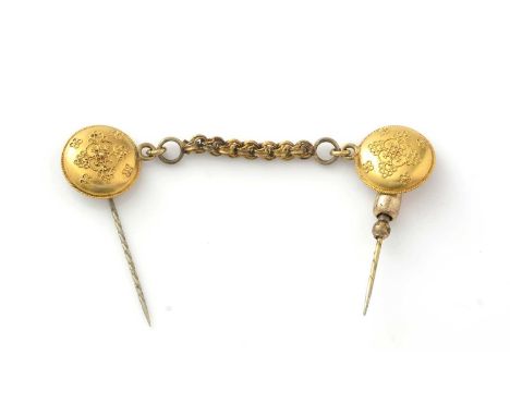 A cloak pin, with 18ct yellow gold roundels, fitted later pins and associate chain, 5.9g gross.