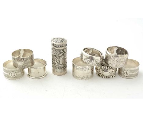 A selection of eight silver napkin rings, various designs and makers; and an Indian silver cylindrical pot with embossed exte