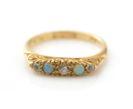 An opal and white stone ring, in scrolling 18ct yellow gold shank, ring size O, 3.8g gross.