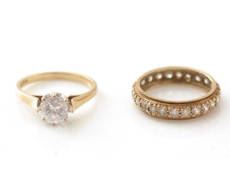 A CZ solitaire ring and a CZ eternity ring, in 9ct yellow gold mounts and shanks, 5.3g gross.