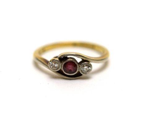 A ruby and diamond three stone ring, the collet set ruby flanked by collet set round brilliant cut diamonds, in twist setting