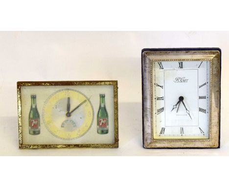 A Silver Framed Clock Together With A Vintage 7 Up Clock