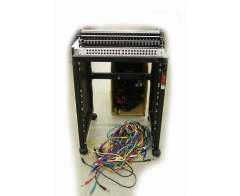 Quiklok rack unit case; together with three twenty-four channel patch bay racks, a large quantity of patch bay and other stud