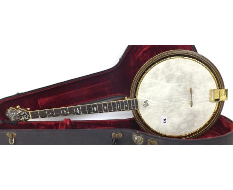 De Wick tenor banjo, circa 1926, the shaped closed peg box labelled S & R, De Wick within inlaid mother of pearl foliage, 19 