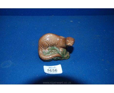 A Beneagles Scotch Whiskey holder by Beswick in he form of an otter.  3'' long x 2 1/2'' tall