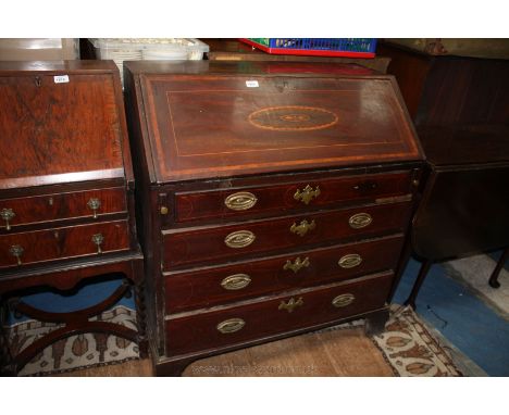 A late 18th c. Mahogany Bureau with plain top, the fall with cross-banded edges and central inlaid oval geometric design, ope