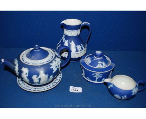 Five pieces of Wedgwood Jasperware in cobalt blue including jug, cream jug, lidded bowl, teapot and stand, spout a/f.