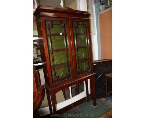 A 19th c. style Mahogany glazed Cabinet on stand, having moulded cornice over opposing pair of glazed single panel doors with