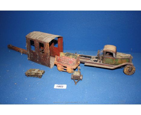 An old distressed Dinky Toys by Meccano Ltd. 152a Light Tank (tracks and turret absent) and an old two wheeled Trailer to mat