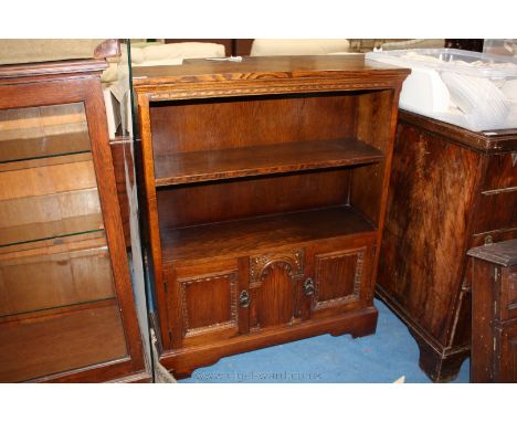 A reproduction Oak Priory style floor-standing open Bookcase, having rectangular top on moulded frieze over single adjustable