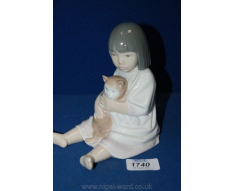 A Nao figure of a little girl playing with a cat.