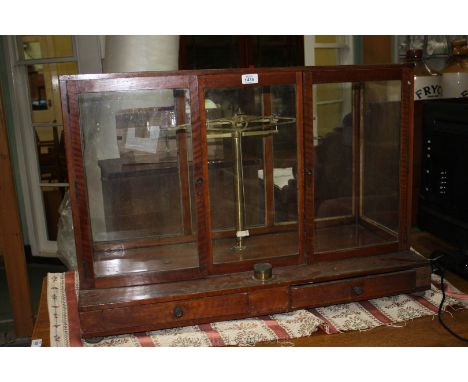 A Chemist's Scales dating from 1850 in wood and glass cabinet, 33 1/2'' wide x 23'' high x 15 3/4'' deep