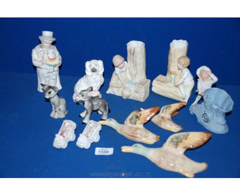 A Victorian nodding figure, a pair of continental spill Vases of a girl and boy playing with water, three flying ducks, noddi