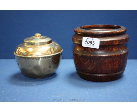 A 1920's oak Tobacco Jar with original porcelain liner and a 1925 British Empire Exhibition brass Tea Caddy.