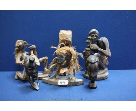 Six wooden African figures including one playing drum, one a mandolin, a figure dancing, a totem and two busts.