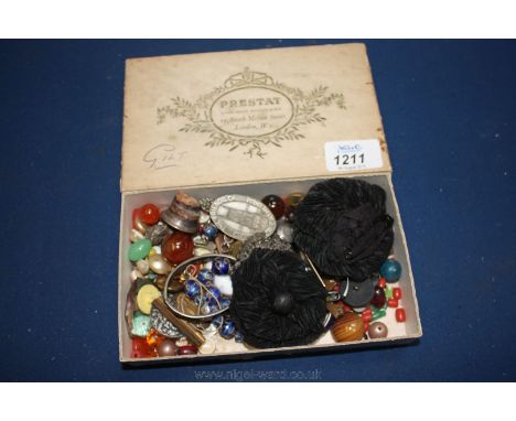 A small box of miscellanea including buttons, enamel badges, bottle stopper, etc.