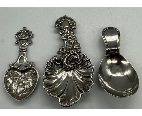 Three silver caddy spoons, one Victorian, another George III and the third Dutch, various makers and designs.
