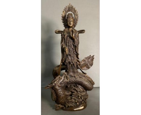 A Chinese brass statue of the dragon god riding a dragon with bottle in hand and offering the sign of peace. Height 56cm
