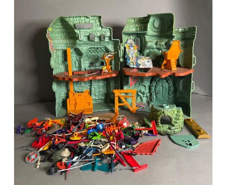  World of He-Man Skeleton's Grey Skull castle (play worn) and a quantity of accessories to include guns, spears and shields 