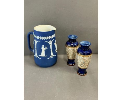 A Wedgewood Jasperware jug along with a pair of Royal Doulton Lambeth stoneware vases