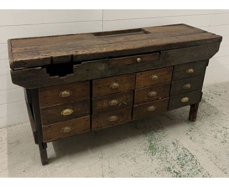 A rustic work bench with brass cup handles (H80cm W153cm D46cm)