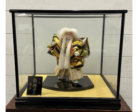A Japanese Kabuki theatre doll "The White Lion" in a glass case 
