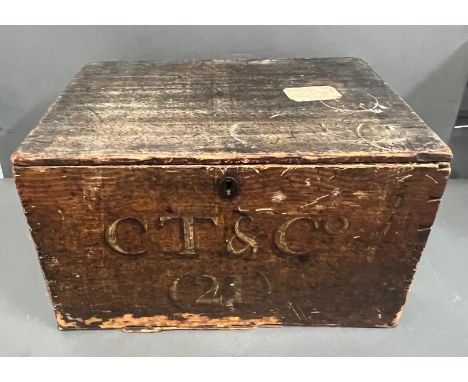 A wooden chest trunk marked CT and Co, with a distressed finish (H29cm W48cm D34cm)