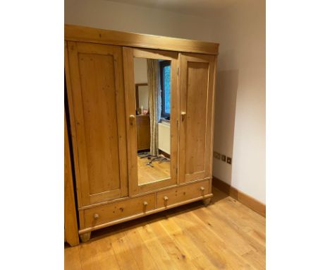 Triple pine wardrobe, three doors to front, mirror to centre and two drawers below (H198cm W158cm D59cm) 