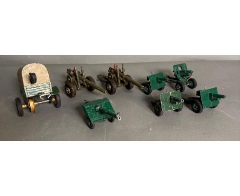 A selection of Diecast models, seven canons and a trailer, various makers to include Meccano and Britain's 