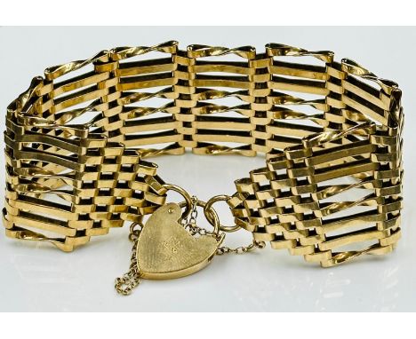 A 9ct gold substantial gate bracelet with heart shaped fastener, approximate total weight 27.5g