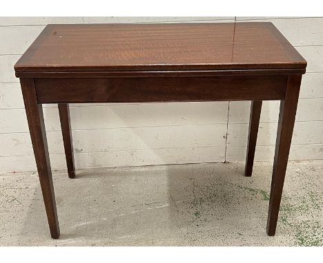 A mahogany card table on square tapering legs opening to a brown velvet playing surface (H74cm W91cm D45cm golded)