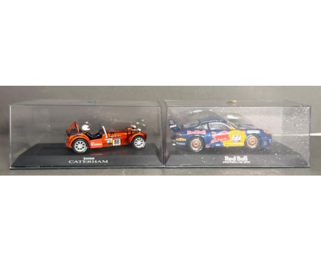 Two cased Scalextric slot racing cars, The Taran Catherham and The Red Bull Porche GT3R