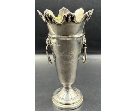 An engraved silver trumpet vase with lion head ring handles, approximate weight 330g, hallmarked for Sheffield 1929 by Walker